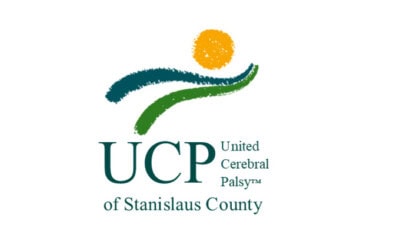 Logo of United Cerebral Palsy of Stanislaus County, featuring an abstract person in green and blue with an orange circle for the head above the text "Helping People Live Fuller Lives".