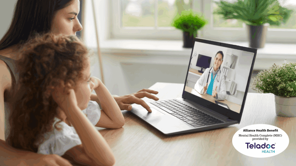 A woman and a child have a video call with a female doctor on a laptop at home. The Teladoc Health logo, along with Alliance Health mental health benefit information, is visible in the corner, highlighting an accessible path to care.