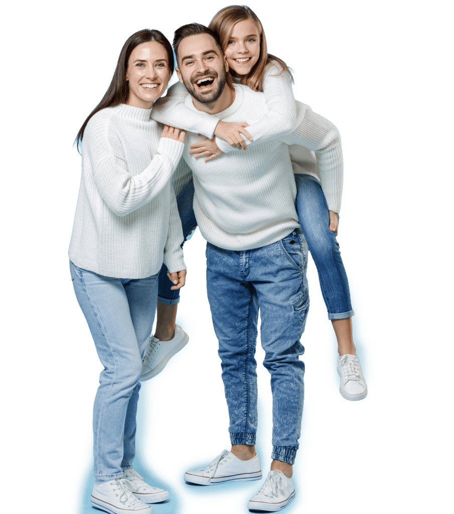 A smiling family—woman, man, and young girl—dressed in white sweaters and blue jeans pose, with the girl on the man's back.